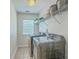 Well-lit laundry room featuring a washer and dryer with shelving for storage and supplies at 2150 Terrabrook Ln, Charleston, SC 29412