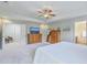 Bright main bedroom featuring a ceiling fan, two dressers, and access to an ensuite bathroom at 2150 Terrabrook Ln, Charleston, SC 29412