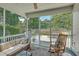 Relaxing screened-in porch featuring comfortable seating, a ceiling fan, and backyard views at 2150 Terrabrook Ln, Charleston, SC 29412