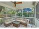 Comfortable screened porch with a large sectional sofa and ceiling fan for relaxing outdoors at 2150 Terrabrook Ln, Charleston, SC 29412