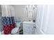 Well-lit bathroom with a vanity, toilet, and shower featuring an attractive curtain, offering functionality and style at 2186 Spoleto Ln, North Charleston, SC 29406