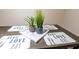 Dining table with decorative place settings and potted plants at 2186 Spoleto Ln, North Charleston, SC 29406