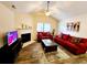 Inviting living room with a fireplace, ceiling fan, and comfortable red couches for a cozy gathering space at 2186 Spoleto Ln, North Charleston, SC 29406
