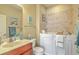 This bathroom features a walk-in tub with safety grab bars and tiled walls at 269 Village Stone Cir, Summerville, SC 29483
