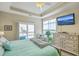 This bedroom boasts a ceiling fan, TV, and sliding glass doors leading to the balcony at 269 Village Stone Cir, Summerville, SC 29483