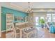 Well-lit dining room with a wooden table and bench seating, decorative shelving, and an exit to the back at 269 Village Stone Cir, Summerville, SC 29483