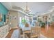 Open dining room featuring a modern chandelier, access to the living room, and an adjacent living room at 269 Village Stone Cir, Summerville, SC 29483