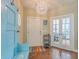 Inviting foyer features a light blue entry bench, coat hooks, hardwood floors and a modern light fixture at 269 Village Stone Cir, Summerville, SC 29483