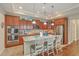 Stylish kitchen featuring stainless steel appliances, wooden cabinets, granite countertops, and an island with barstool seating at 269 Village Stone Cir, Summerville, SC 29483
