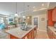 Open kitchen with an island that has barstool seating, a pantry, and views of the dining and living area at 269 Village Stone Cir, Summerville, SC 29483