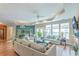 Bright living room with a ceiling fan, fireplace, plush seating, and open access to the dining and kitchen areas at 269 Village Stone Cir, Summerville, SC 29483