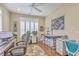 Bright office space featuring hardwood floors, a ceiling fan, and ample natural light through shuttered windows at 269 Village Stone Cir, Summerville, SC 29483