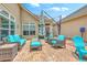 Inviting patio with wicker seating, vibrant cushions, and shade provided by a large umbrella at 269 Village Stone Cir, Summerville, SC 29483