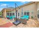 Cozy patio area with wicker furniture, blue cushions, and an umbrella at 269 Village Stone Cir, Summerville, SC 29483