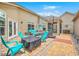 Outdoor patio furnished with a dining table, chairs, and a firepit for relaxing or entertaining at 269 Village Stone Cir, Summerville, SC 29483