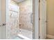 Walk-in shower with tiled walls, a built-in seat, and grab bars at 269 Village Stone Cir, Summerville, SC 29483
