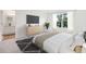 A spacious main bedroom with a large window and hardwood flooring at 2704 Scarlett Maple St, Summerville, SC 29486