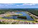 Expansive aerial shot showcasing a planned community nestled around a lake with walking trails and green areas at 2961 Sweetleaf Ln, Johns Island, SC 29455
