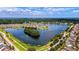 Breathtaking aerial view of a residential community surrounding a serene lake and lush green spaces at 2961 Sweetleaf Ln, Johns Island, SC 29455