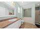 Bathroom boasts tile flooring, vanity and mirror, with separate tub and shower at 2961 Sweetleaf Ln, Johns Island, SC 29455