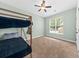 Bright bedroom featuring a bunk bed, ceiling fan, and a window with natural light at 2961 Sweetleaf Ln, Johns Island, SC 29455