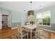 Dining room with a bright window, wood floors, and a view into the bathroom at 2961 Sweetleaf Ln, Johns Island, SC 29455