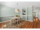 Inviting dining room featuring stylish decor, hardwood floors, and a modern light fixture at 2961 Sweetleaf Ln, Johns Island, SC 29455