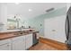 Bright kitchen features a double sink, tile flooring, white cabinets and stainless-steel appliances at 2961 Sweetleaf Ln, Johns Island, SC 29455