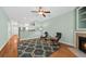 Inviting living room with fireplace and ceiling fan flows into adjacent kitchen at 2961 Sweetleaf Ln, Johns Island, SC 29455