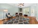 Cozy living room with fireplace, ceiling fan, and plenty of natural light at 2961 Sweetleaf Ln, Johns Island, SC 29455
