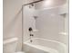 Bathroom with tiled shower and bathtub featuring built-in niche, plus a toilet and bronze hardware at 299 Lucca Dr, Summerville, SC 29486
