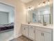 A bathroom with double sinks, modern fixtures, and a view into the bedroom showcasing the home's design at 299 Lucca Dr, Summerville, SC 29486