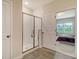 This bathroom features a modern shower with a glass door and a glimpse into the bedroom area at 299 Lucca Dr, Summerville, SC 29486