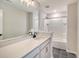 Modern bathroom featuring white cabinetry, a large mirror, and a bathtub with tiled surround at 299 Lucca Dr, Summerville, SC 29486