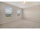 Bright bedroom with neutral walls, plush carpet, and two windows with blinds, allowing ample natural light at 299 Lucca Dr, Summerville, SC 29486