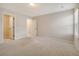 Spacious bedroom with plush carpeting, neutral walls, and an open closet featuring wire shelving at 299 Lucca Dr, Summerville, SC 29486