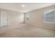 This bright, carpeted bedroom has multiple windows offering plenty of natural light at 299 Lucca Dr, Summerville, SC 29486