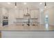 Open kitchen with pendant lighting, stainless appliances, and a large center island with sink at 299 Lucca Dr, Summerville, SC 29486