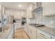 Bright kitchen featuring stainless steel appliances, white cabinetry, and a gray backsplash at 299 Lucca Dr, Summerville, SC 29486