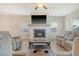 Spacious living room with a fireplace, ceiling fan, and large windows, creating a warm and inviting atmosphere at 299 Lucca Dr, Summerville, SC 29486