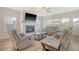 Cozy living room with a fireplace, large TV, and comfortable seating, perfect for relaxing and entertaining at 299 Lucca Dr, Summerville, SC 29486
