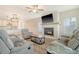 Cozy living room with fireplace and open concept layout, providing a seamless flow into the kitchen and dining areas at 299 Lucca Dr, Summerville, SC 29486