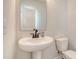 Modern powder room featuring a pedestal sink, a sleek faucet, and a clean, minimalist design at 299 Lucca Dr, Summerville, SC 29486