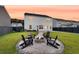 Inviting backyard featuring a fire pit surrounded by Adirondack chairs, perfect for outdoor entertaining at 3018 Vincent Astor Dr, Johns Island, SC 29455