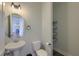 Half bath with a pedestal sink, modern fixtures, and a view into another room at 3018 Vincent Astor Dr, Johns Island, SC 29455