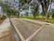 Well maintained community bocce ball court complete with benches and a rake for grooming the playing surface at 3018 Vincent Astor Dr, Johns Island, SC 29455