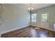 Cozy dining room with hardwood floors, modern chandelier, and a bright window at 3018 Vincent Astor Dr, Johns Island, SC 29455