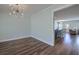 Bright dining room with contemporary chandelier and hardwood flooring, open to adjacent kitchen and living area at 3018 Vincent Astor Dr, Johns Island, SC 29455