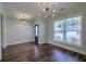Open bonus room features dark floors, windows and designer light fixture and a transom window at 3018 Vincent Astor Dr, Johns Island, SC 29455