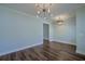 This bonus room has two designer light fixtures and dark wood floors at 3018 Vincent Astor Dr, Johns Island, SC 29455